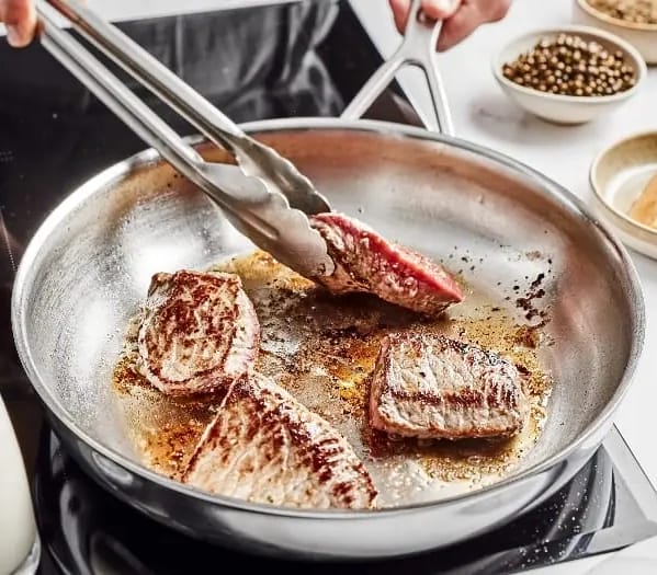 Demeyere-frying-pan-with-man-cooking-steak