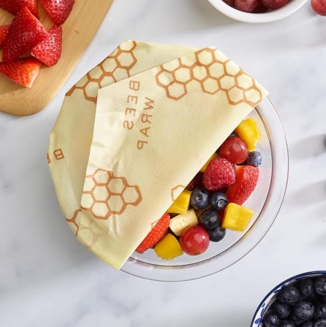 Bees-Wraps-wax-produce-storage-wrap-covering-bowl-of-mixed-fruit