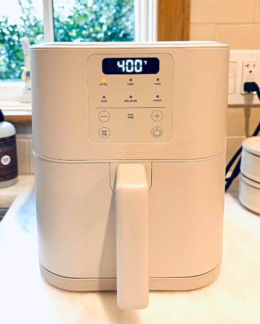 Image of the Bella Teflon-free air fryer sitting on a white countertop with window in the background